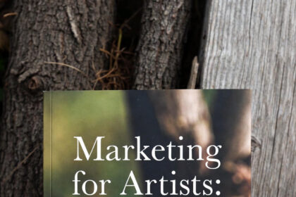 An artist filming a time-lapse video of their painting process for social media content, demonstrating digital marketing for artists.