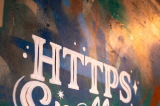 Teacher and students using VocabularySpellingCity on a secure HTTPS-enabled laptop in a classroom setting.